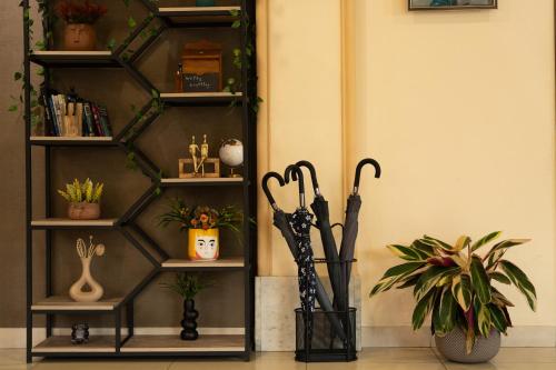 a shelf with two umbrellas in a room at Inga Hotel Yerevan in Yerevan