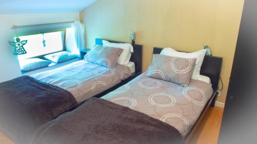 a bedroom with two beds and a couch at Les 3 pruniers in Cieux