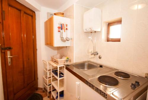 a small kitchen with a sink and a stove at Studio Marin in Baška