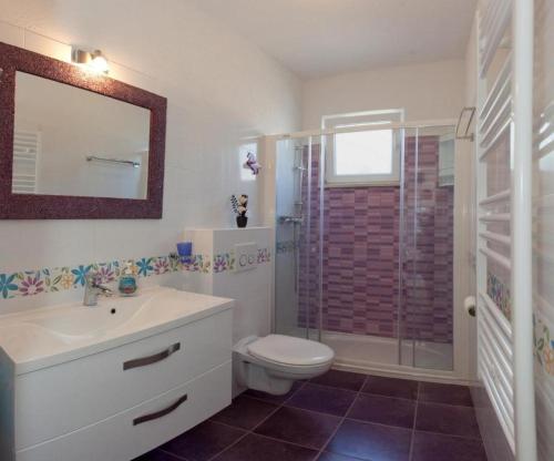 a bathroom with a toilet and a sink and a shower at Apartments Paradise With Amazing Sea View in Vinišće