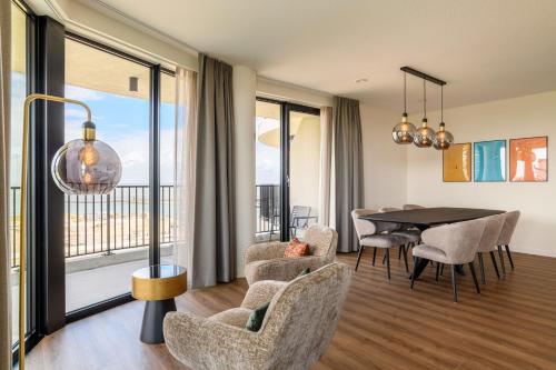 a living room with a table and chairs and a dining room at Dormio Breskens Apartments & Penthouses in Breskens