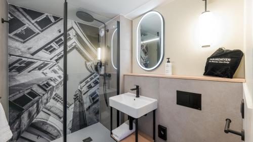 a bathroom with a sink and a shower at Campanile NATURE - Lyon Est Bron Eurexpo in Bron
