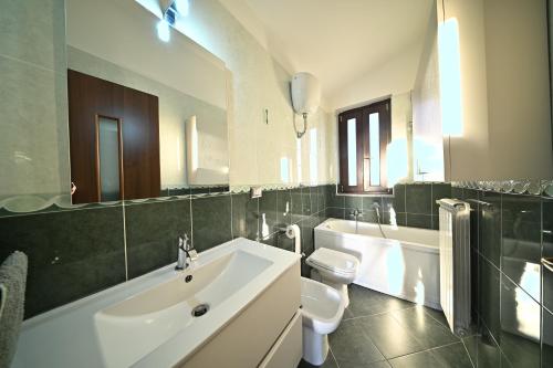 a bathroom with a white sink and a toilet at La Terrazza Sidicina Home in Teano