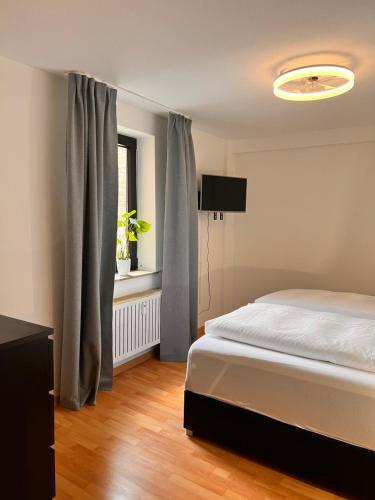 a bedroom with a bed and a window at City Apartment 1 in Euskirchen