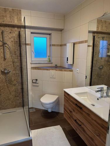 a bathroom with a toilet and a sink and a shower at Villa Nikki in Bilice