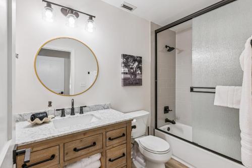 a bathroom with a sink and a toilet and a mirror at Harbour Oaks, Unit 618 in Saint Simons Island