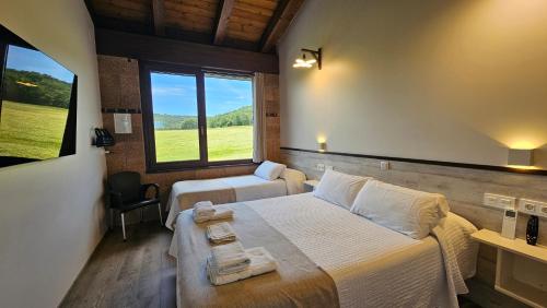 a bedroom with a bed and a couch and a window at Casa Nahia Hostal Rural in Lorca