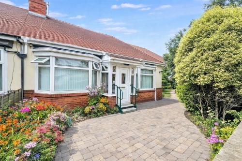 a brick house with a brick driveway at 3 Bed Bungalow with Large Garden in Westoe
