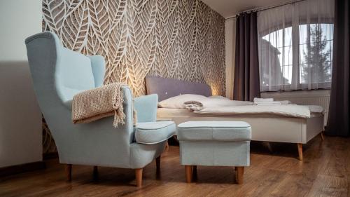 a bedroom with a bed and a table and chairs at Relax & Luxury apartment in Veľká Lomnica