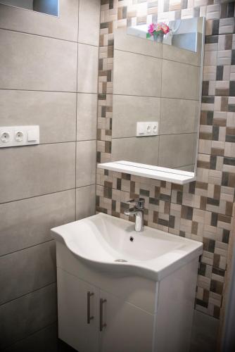 a bathroom with a sink and a mirror at Mona Apartman in Sárvár
