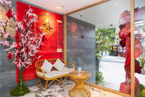 a room with a chair and a table and a window at SHI HOUSE by Haviland in Danang