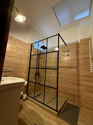 a shower with a glass door in a bathroom at Urban Stillness - 3BD Hideaway in Bucharest