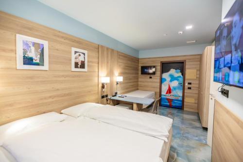 a bedroom with a bed and a desk in it at Ferrucci Rooms in Marina di Cecina