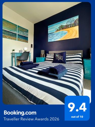a bedroom with two beds with blue walls at Seaside Apartment close to beach, town, station in Broadstairs