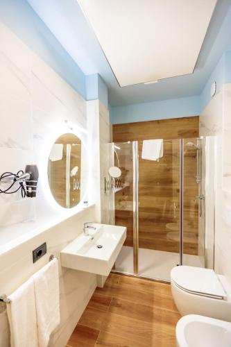 a bathroom with a toilet sink and a shower at Ferrucci Rooms in Marina di Cecina
