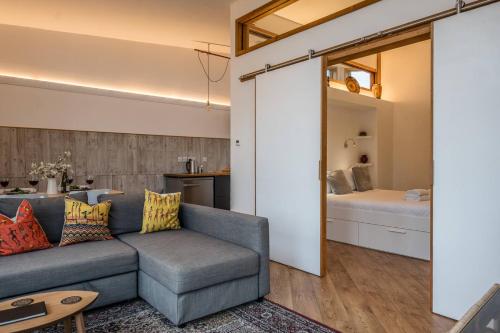 a living room with a couch and a bedroom at The Orchard Annexe, Framlingham in Framlingham