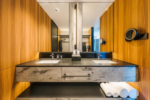 a bathroom with two sinks and a large mirror at Intercity Hotel & Serviced Apartment Phnom Penh Downtown in Phnom Penh