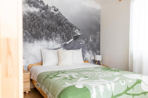 a bedroom with a bed with a painting of a mountain at Markowa Chata in Mizerna