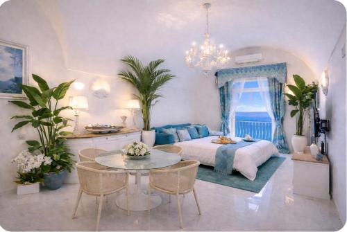 a bedroom with a bed and a table with chairs at Villa Navarra in Praiano
