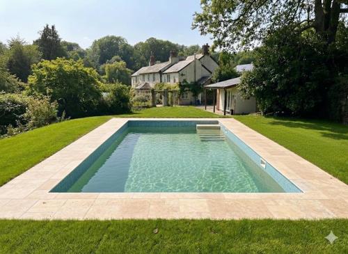 a swimming pool in the yard of a house at Lower Marsh Farm in Cornwall in Saltash