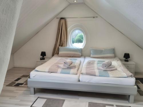 a bedroom with two beds with towels on them at Stadtvilla Norden in Norden