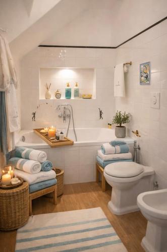 a bathroom with a tub and a toilet and a sink at Villa Navarra in Praiano