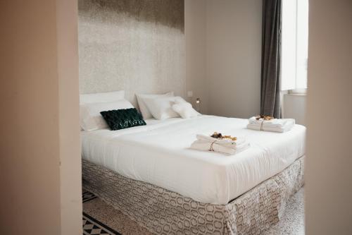a large white bed with two pillows on it at Dimora Sant'Allegria in Lecce