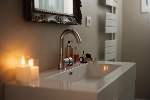 a bathroom with a sink with candles and a mirror at Dimora Sant'Allegria in Lecce