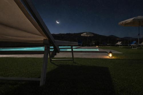 a view of a swimming pool at night at La Casa di Mary in Amelia