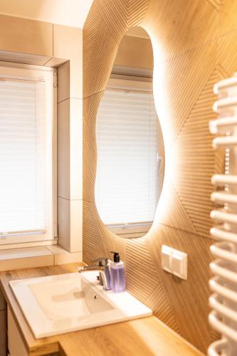 a bathroom with a sink and a mirror at Markowa Chata in Mizerna