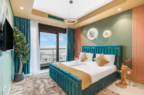 a bedroom with a blue bed and a large window at Luxury Apartments with Rooftop Pool in Paramount Hotel Midtown By Aurora in Dubai