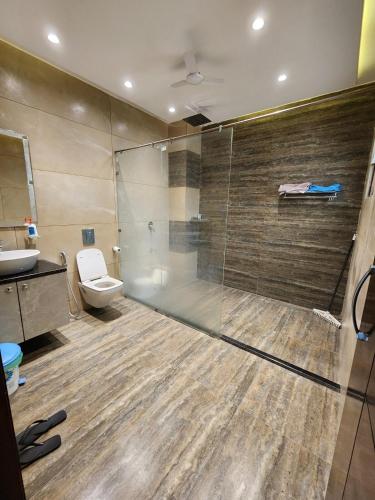 a bathroom with a shower and a toilet and a sink at The leaf and Hill in Alwar