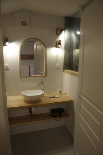 a bathroom with a sink and a mirror at Appartement LE CHAI in Saint-Gaudens