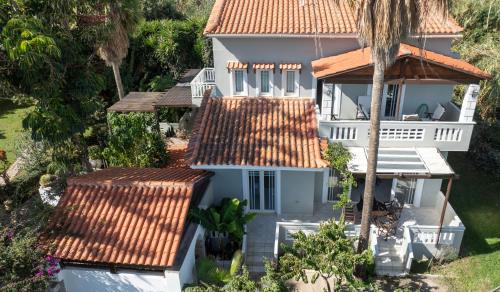 an aerial view of a white house with red tile roofs at Esperado Gardens Maleme in Maleme