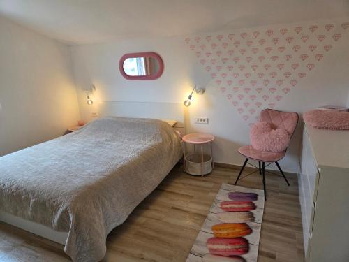 a bedroom with a bed and a chair and a window at Apartment Mia 2 in Rab