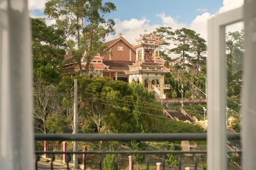 a house on a hill with a building on it at Hill Side Town Hotel DaLat in Da Lat