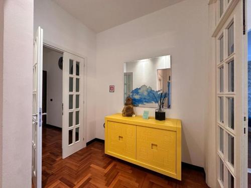 a yellow dresser in a room with a yellow mirror at Appartamento Rosa in Gualdo Tadino