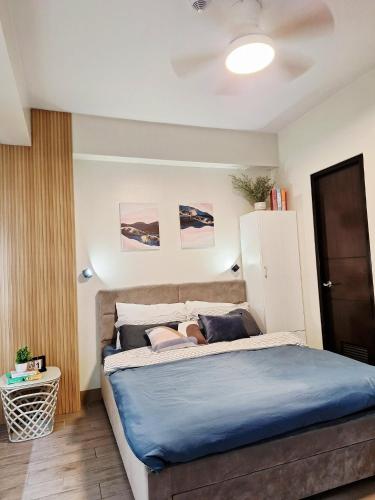 a woman laying on a bed in a bedroom at Studio 7C at One Regis in Bacolod