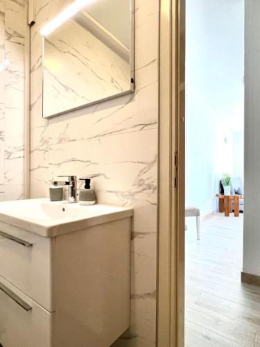 a white bathroom with a sink and a mirror at Villa Sarah in Selca