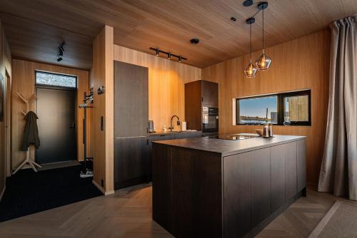 a kitchen with a island in the middle of a room at Secluded Lodge - Stunning Views! in Storøya