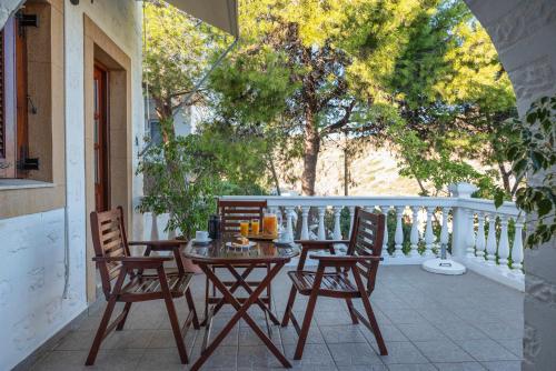 a patio with a table and chairs on a balcony at Irene Studios Patmos in Skala
