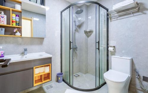 a bathroom with a shower and a toilet and a sink at Kalm apartment- Luxury Living with a Gym, Heated Pool & Stunning Views in Nairobi