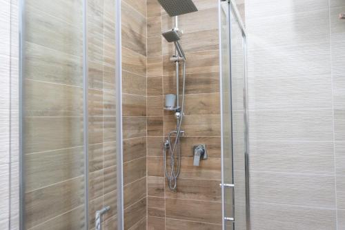 a shower with a glass door in a bathroom at Casa di Nonna Nì - Due alloggi con scala interna condivisa in Portocannone