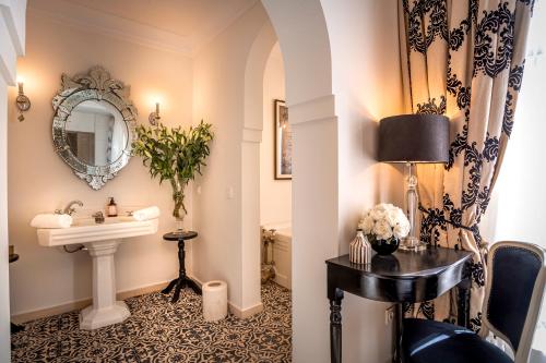 a bathroom with a sink and a mirror at Riad Anaqa in Marrakesh