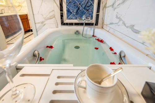 a bath tub with a cup of coffee in it at 悦江阁美宿 in Chongqing