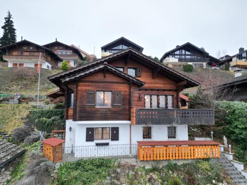 a wooden house on top of a hill at Studio Lake View Faulensee in Faulensee