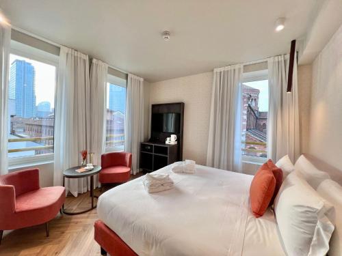 a hotel room with a large bed and large windows at Best Western Madison Hotel in Milan