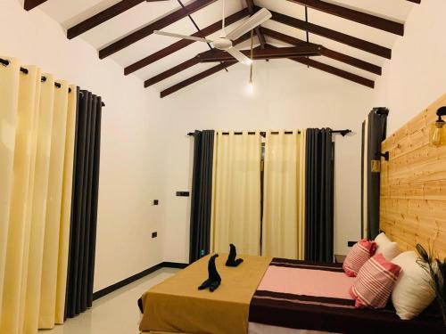 a bedroom with two cats sitting on a bed at water lily heaven in Tangalle