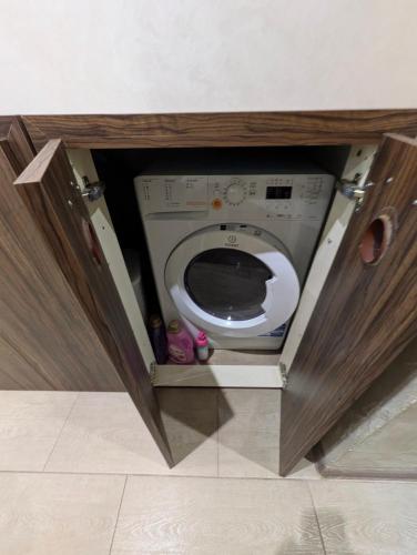 a small bathroom with a toilet in a cabinet at Наслада in Panagyurishte