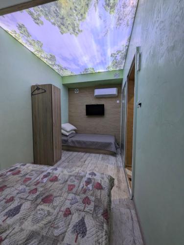 a bedroom with a bed and a skylight on the ceiling at Наслада in Panagyurishte